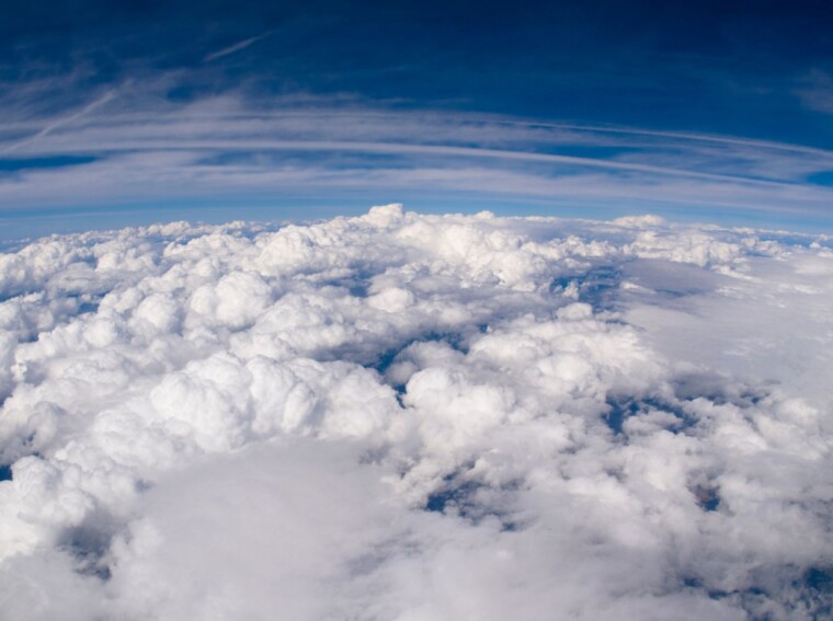 on a day with complete cloud cover, what happens to the visible light headed toward earth?